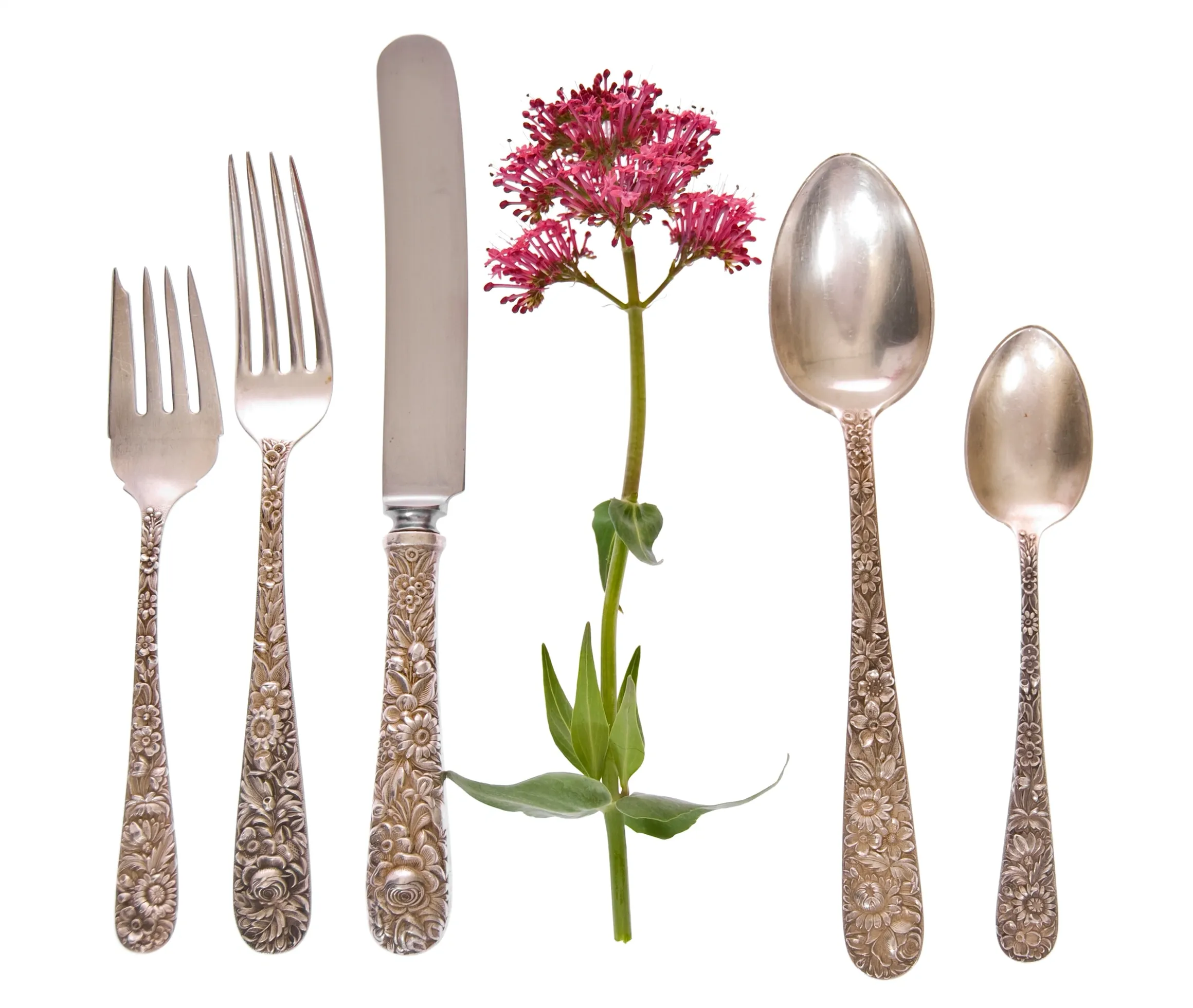 Ornate cutlery and flower arrangement